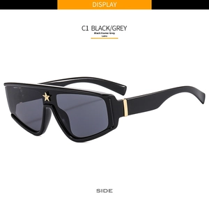 Side view of C1 black oversized sunglasses featuring a golden star emblem on the bridge