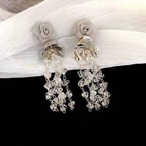 Detail of rose tassel earrings with silver flower studs and crystal bead chains