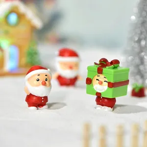 Miniature Santa Claus figurines in a snowy Christmas landscape for DIY micro decorations
