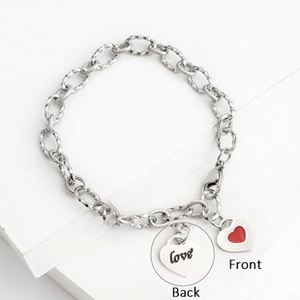 Detailed front and back view of silver heart charms with love engraving and red pattern