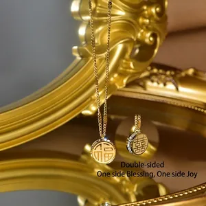 Close-up of gold stainless steel necklace with double-sided Fu and Xi characters
