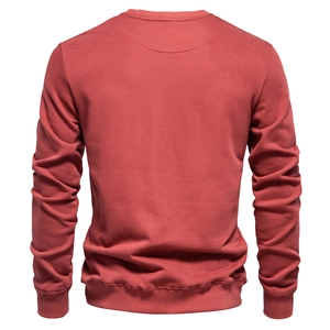 Rear view of a brick red long sleeve crewneck sweatshirt with ribbed cuffs and hem detail