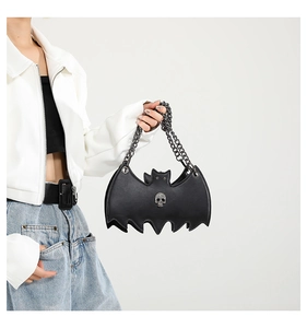 Detail view of gothic bat-shaped jelly bag with skull studs and metal chains
