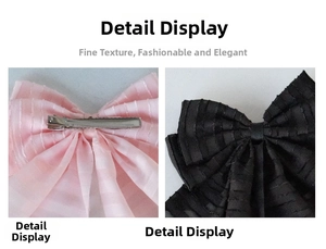 Detail showing pink bow hair clip with silver metal alligator clamp and black fabric ribbon
