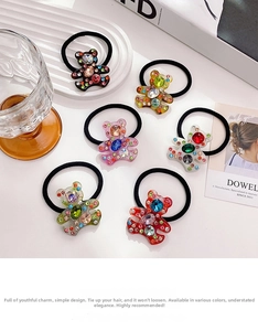 Detailed close-up of six crystal bear hair ties with colorful rhinestones on a white background