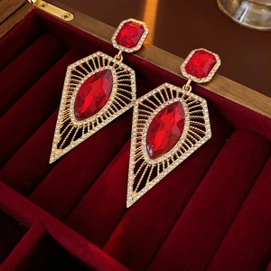 Vintage gold-plated earrings with red marquise gems and rhinestones on velvet box
