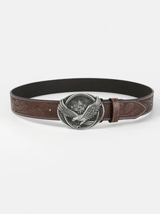 Detail of vintage eagle buckle and embossed floral patterns on brown leather belt