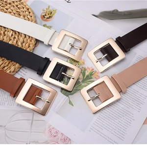 Flat lay of multiple minimalist waist belts with polished gold square buckles in 5 colors