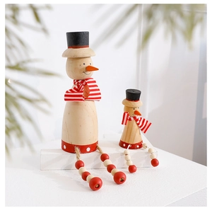 Detailed view of two wooden snowman figurines with red scarves and hats on white stand