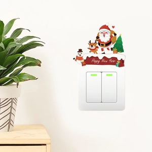 Close-up of watercolor Santa and reindeer wall stickers above a double light switch