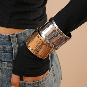 Modern irregular wide metal bangles with vertical wave texture in gold and silver