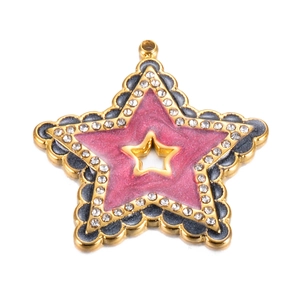 Macro shot of gold star pendant with pink glitter enamel and sparkling rhinestones
