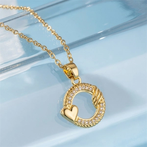 18K gold French style necklace with circular pendant and heart-shaped zircon stones