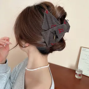 Dark grey denim fabric bow hair claw clip with red embroidery for elegant updos