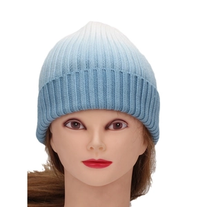 Women's blue and white gradient tie-dye beanie featuring a ribbed knit roll-up cuff