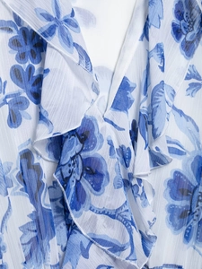 Detailed view of blue floral chiffon fabric with soft ruffled edges and delicate texture