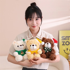 Three Christmas teddy bears in white, yellow and brown held by a smiling model