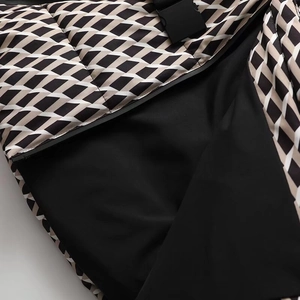 Detail of quilted winter jacket showing zipper and two-tone contrast fabric texture