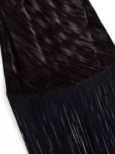 Detail of dark brown pleated velvet fabric with elegant long black tassel fringe trim