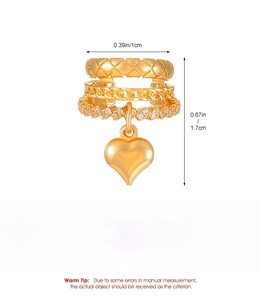 Detail of gold heart ear cuff with quilted pattern, chain texture and zircon inlay