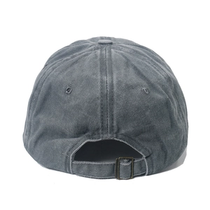 Detail view of washed cotton baseball cap with adjustable bronze metal buckle