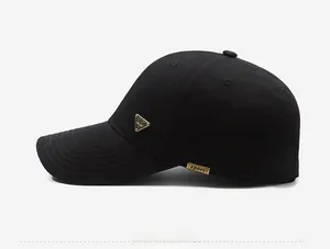 Detail of a black cotton baseball cap showing side metal plate with Sport engraving