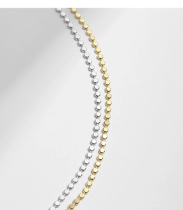 Macro shot of minimalist S925 silver and gold beaded choker chain links detail