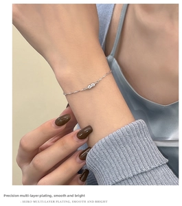 Detail of silver water wave bracelet featuring two sparkling round zircons on wrist