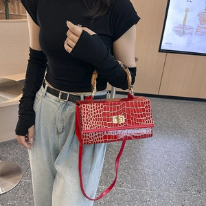 Fashionable red croc-effect handbag with bamboo handle and gold lock, stylish shoulder bag