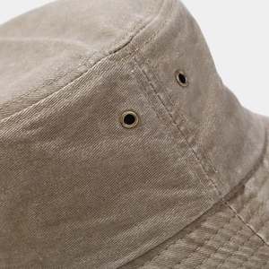Detail of vintage khaki cotton sun hat showing metal ventilation eyelets and stitching