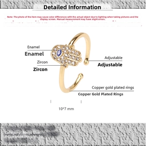 Detail view of gold-plated Hamsa Hand ring with blue enamel Evil Eye and zircons