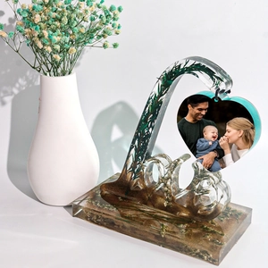 Detailed view of LOVE heart photo frame mold with embedded dried flowers for resin