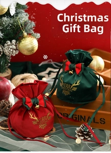 Detail of velvet Christmas drawstring gift bags with reindeer antlers and golden bells