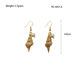 Detail view of golden conch shell earrings with mother of pearl and product dimensions