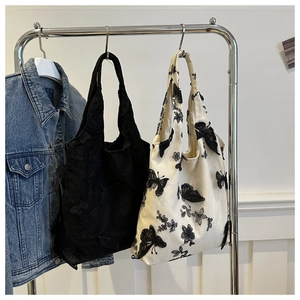 Black and white canvas tote bags with 3D butterfly embroidery in a casual shoulder style