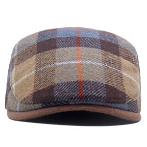 Detail of wool blend newsboy cap showing classic plaid pattern and vintage texture