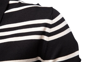 Close-up of knit fabric and shoulder seam on a black and white striped polo sweater