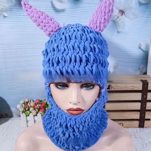 Detail of royal blue balaclava featuring knitted devil horns and thick chenille texture