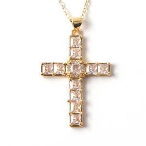 Close-up of gold-plated cross pendant featuring square zircon stones on an O-chain necklace
