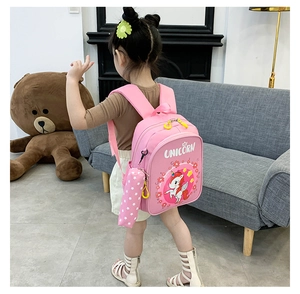 Pink unicorn kids backpack shown on child model with matching pencil case accessory