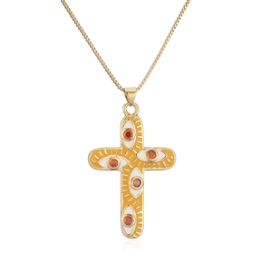 Close-up of 18K gold-plated cross pendant with white enamel eye motifs and orange stones