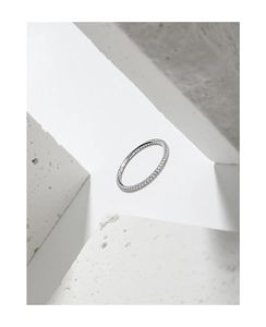 Macro detail of a minimalist S925 sterling silver eternity ring with zircon stones