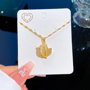 Gold tulip necklace with yellow cat eye stone and rhinestones on jewelry card