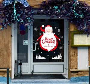 Close-up of Santa Claus window sticker with Merry Christmas greeting and snowflakes