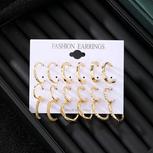 Set of 12 gold vintage C-shape and hoop earrings with pearls on white display card