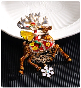 Detailed view of Christmas reindeer brooch with colorful enamel and snowflake pendant