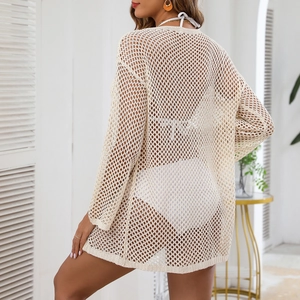 Detalle del vestido de playa de punto beige con diseño calado y aberturas laterales