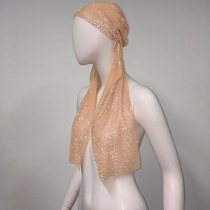 Detailed view of champagne mesh turban with dense rhinestones for party hair styling