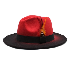 Gradient red and black wool fedora hat with black ribbon and colorful feather accent
