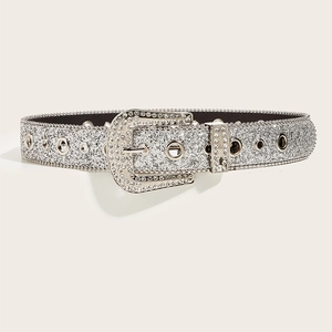 Close-up of a silver Y2K rhinestone belt featuring shiny glitter and metal eyelets